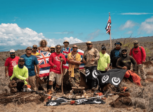 THE ALALOA (TRAIL CLEARING) TEAM AND THE HAWAIIAN FLAG LEFT STANDING AFTER THE FEBRUARY FIRE WHICH BURNED 9,000 ACRES (PHOTO: PO`OKELA HANSEN).