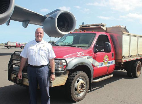 Chief Moller with One Of The Two Brush Trucks For PTA That Were Transported Via A C-17 From Oahu To Ellison Onizuka International Airport At Keahole In March 2018. Photo: Chelsea Jensen - West Hawaii Today.