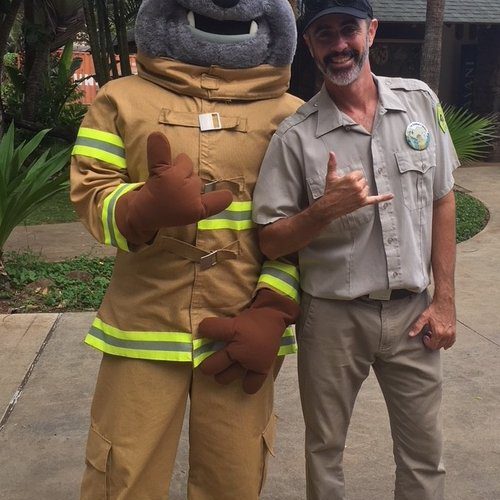 MIKE SHAKAS WITH POKI, HONOLULU FIRE DEPARTMENT’S MASCOT AT THE HONOLULU ZOO DURING FIRE PREVENTION WEEK. PHOTO: MIKE WALKER
